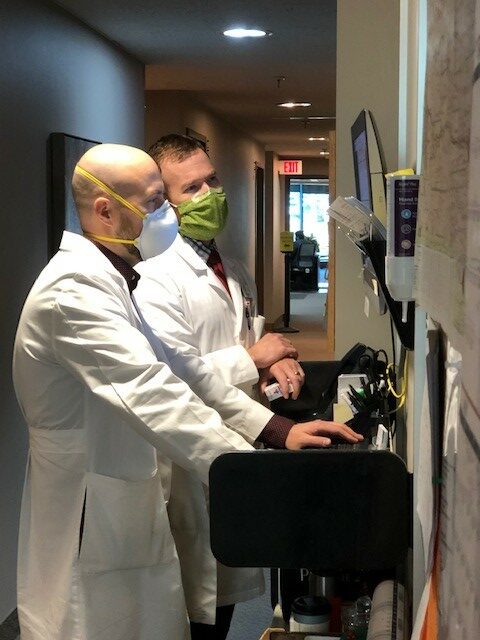 Doctors looking at screen
