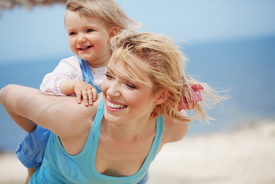 Woman carrying a toddler on her back