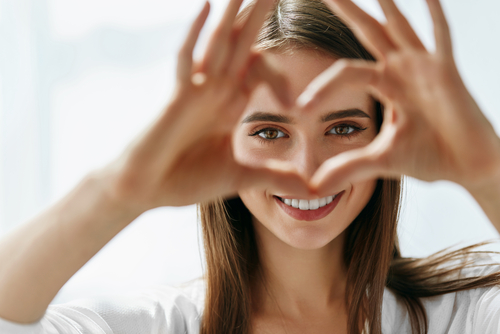 Person making a heart with their fingers